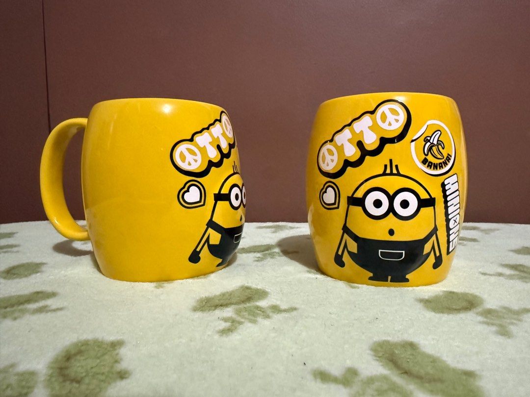 Universal Studios SG Minions Mug (900 each) (Category: Coffee & Tea Tableware) located in Quezon City. Submitted by skyeseller (Listing ID 1401255620, Image 1). Description: - Universal Studios SG Minions Mug - Features a bright yellow color - Adorned with Otto and other Minion graphics - In good condition - Perfect for Minions fans and collectors.