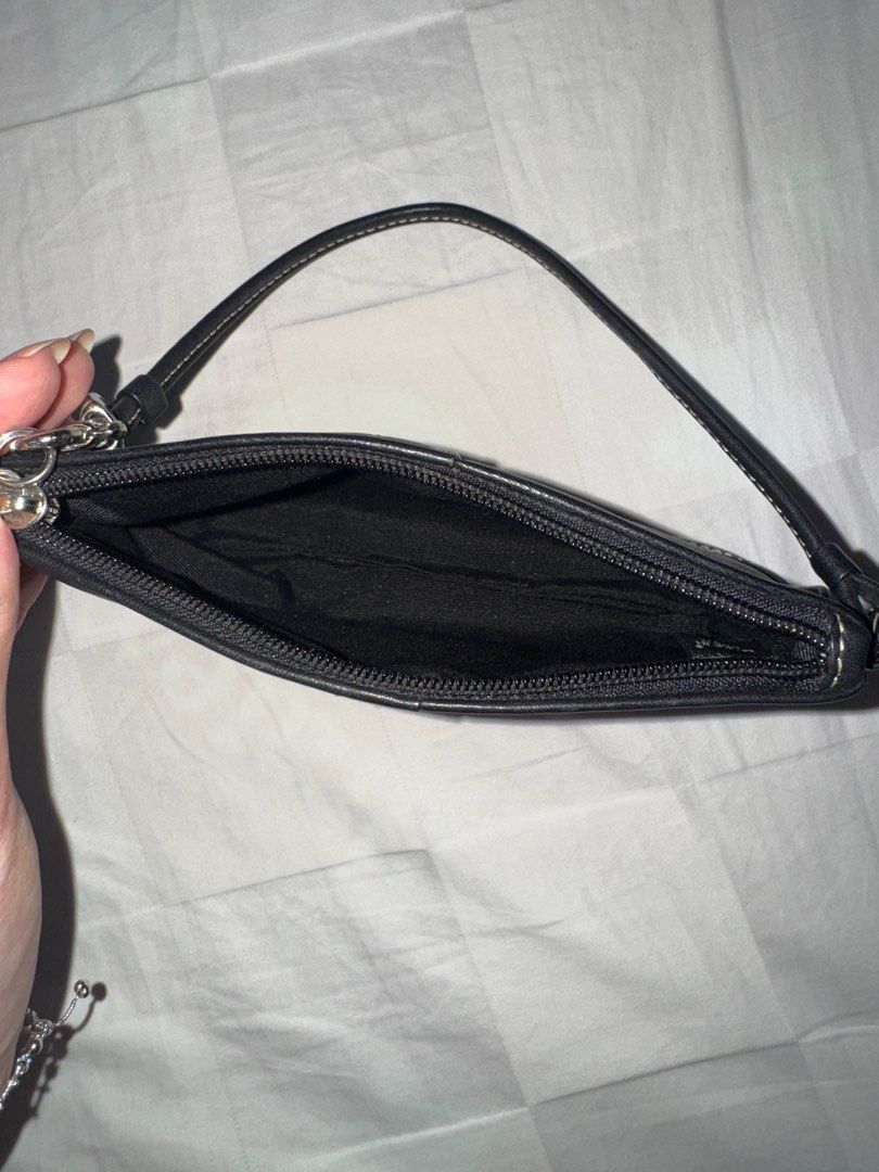 Vintage Coach Black Wristlet (Category: Luxury Bags & Wallets) located in Manila. Submitted by decluterrrr (Listing ID 1401296053, Image 3). Description: - Leather is in good condition - Black Coach wristlet - Wrist strap included - Secure zipper closure - Features a small Coach tag - Black interior - White stitching details - Made of leather - Estimated from the early 2000s.