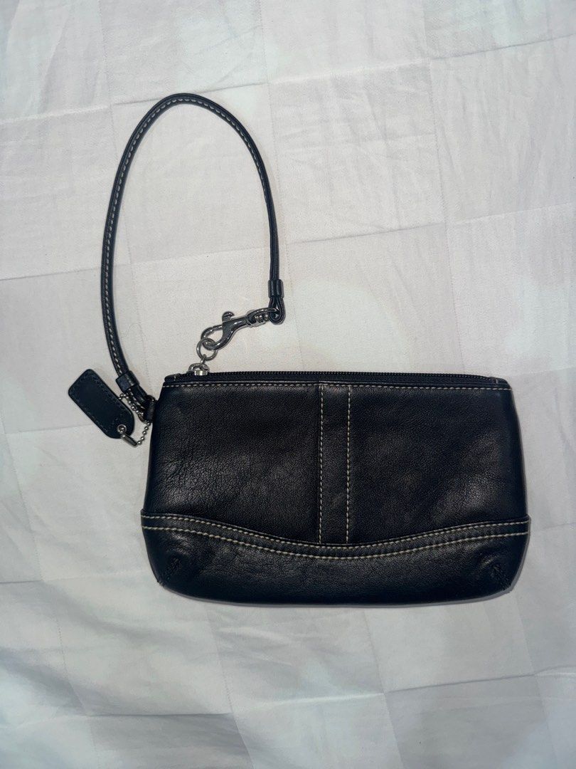 Vintage Coach Black Wristlet (Category: Luxury Bags & Wallets) located in Manila. Submitted by decluterrrr (Listing ID 1401296053, Image 1). Description: - Leather is in good condition - Black Coach wristlet - Wrist strap included - Secure zipper closure - Features a small Coach tag - Black interior - White stitching details - Made of leather - Estimated from the early 2000s.