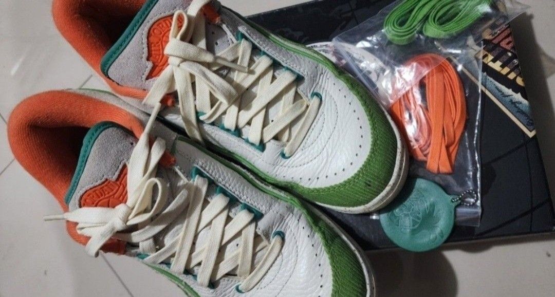Air Jordan 2 Retro Low Titan (Category: Sneakers) located in Bulacan. Submitted by tchrdeclutters (Listing ID 1401517598, Image 3). Description: Air Jordan 2 Retro Low Titan shoes in Sail/Chlorophyll/Coconut Milk/Safety Orange colorway. Includes extra laces. Size US W 8 / M 6.5. Style DV6206-183. The shoes are in the original box..