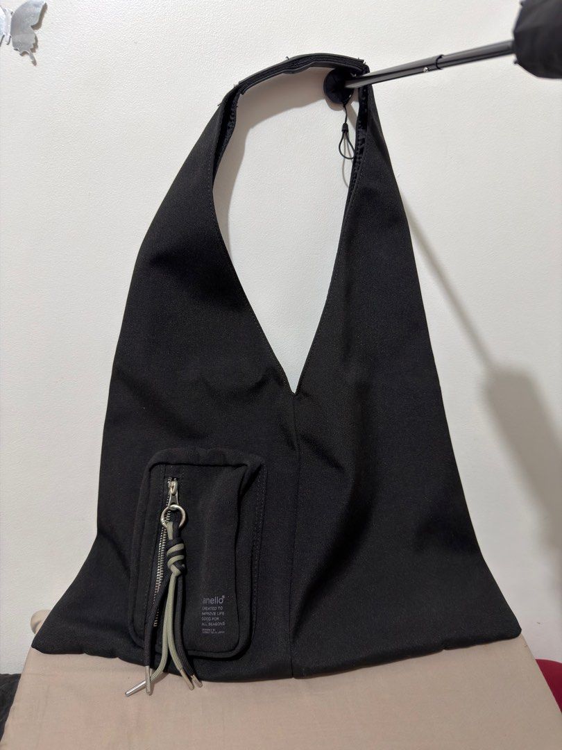 Anello Black Dorothy Tote Bag (Category: Tote Bags) located in Pasig City. Submitted by vince.declutters (Listing ID 1401485981, Image 1). Description: - Black Anello tote bag - Front pocket with zipper closure - Decorative cord detail - Single shoulder strap - Triangular design - Made of sturdy fabric - Original price: 2,990 at Anello, Megamall.