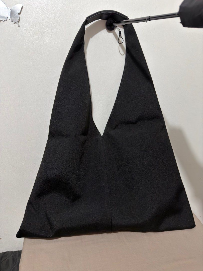 Anello Black Dorothy Tote Bag (Category: Tote Bags) located in Pasig City. Submitted by vince.declutters (Listing ID 1401485981, Image 2). Description: - Black Anello tote bag - Front pocket with zipper closure - Decorative cord detail - Single shoulder strap - Triangular design - Made of sturdy fabric - Original price: 2,990 at Anello, Megamall.