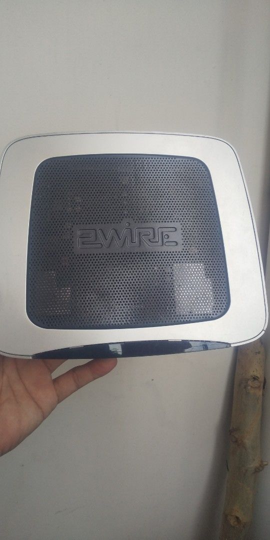 BT Broadband Router (Category: Networking) located in Carmona. Submitted by rpute (Listing ID 1401367039, Image 2). Description: - BT 3700HGV Router - Silver and black design - Multiple ports: Ethernet, USB - Power button - Indicator lights - 'ewire' logo - Power input.