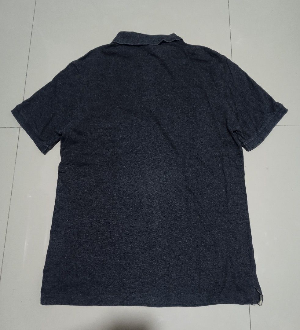 Burberry Polo Shirt (Category: Tshirts & Polo Shirts ) located in Caloocan City. Submitted by wupeeram (Listing ID 1401458409, Image 2). Description: - Dark grey Burberry polo shirt - Features Burberry logo on chest - Made in Turkey - Classic polo collar and short sleeves - Size tag visible.