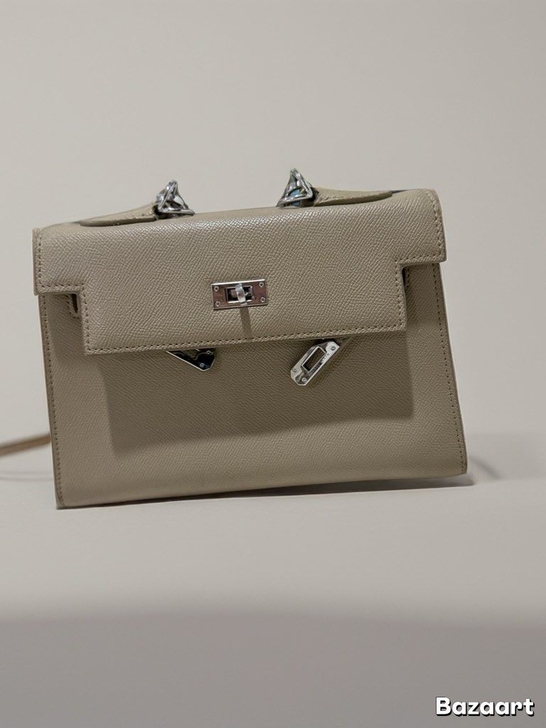 Charles and Keith bag (Category: Luxury Bags & Wallets) located in Quezon City. Submitted by syogrl (Listing ID 1401412651, Image 1). Description: - Neutral beige color - Structured design - Top handle - Flap closure - Silver-tone hardware - with shoulder strap.