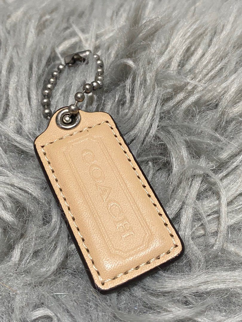 Coach Leather Keychain Tag (Category: Shoulder Bags) located in Balanga. Submitted by vintagefanatics (Listing ID 1401363091, Image 3). Description: Coach keychain tag. Beige leather with embossed logo. Silver-tone chain. Rectangular shape..