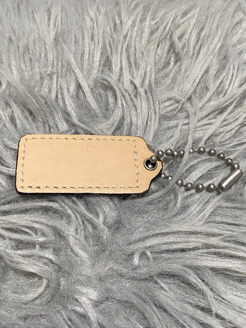 Coach Leather Keychain Tag (Category: Shoulder Bags) located in Balanga. Submitted by vintagefanatics (Listing ID 1401363091, Image 2). Description: Coach keychain tag. Beige leather with embossed logo. Silver-tone chain. Rectangular shape..