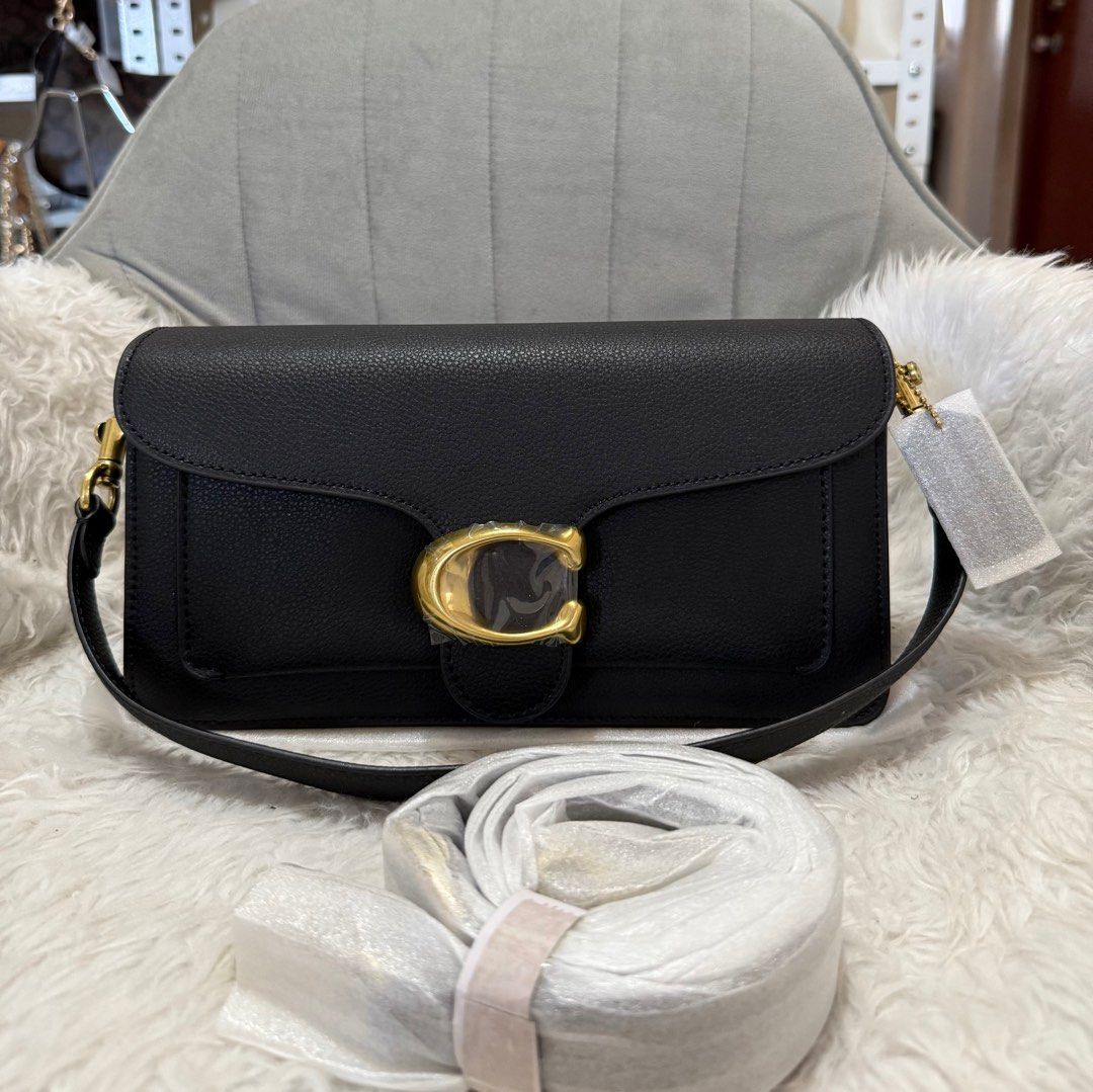 Coach Tabby 26 Shoulder Bag (Category: Luxury Bags & Wallets) located in Las Pinas. Submitted by yhn_boutique (Listing ID 1401382003, Image 1). Description: - Brand new Coach Tabby shoulder bag - Features a stylish gold-tone 'C' logo - Includes a detachable shoulder strap for versatile wear - Crafted from luxurious textured leather - Comes with original tags attached.