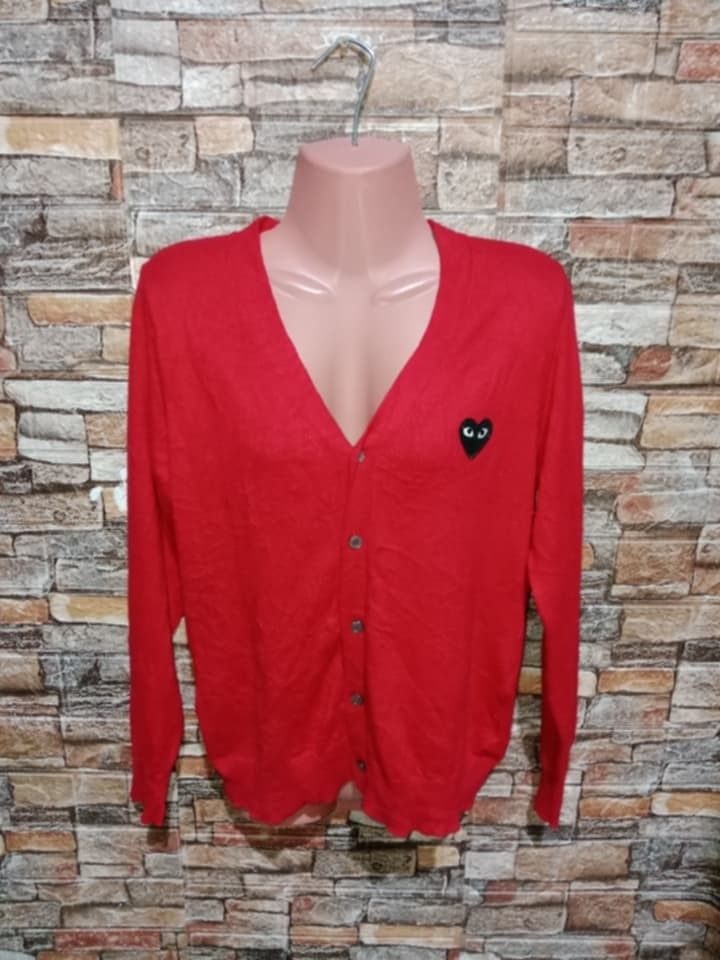Comme des Garcons Play Red Cardigan ( small to medium) (Category: Coats, Jackets and Outerwear) located in Arayat. Submitted by keenwolf-a7b5 (Listing ID 1401487643, Image 3). Description: - Comme des Garcons Play cardigan - Red color - Features iconic black heart logo - V-neck design - Button closure - Made in Japan - Small to medium -Dimes 18.5 x 24 .