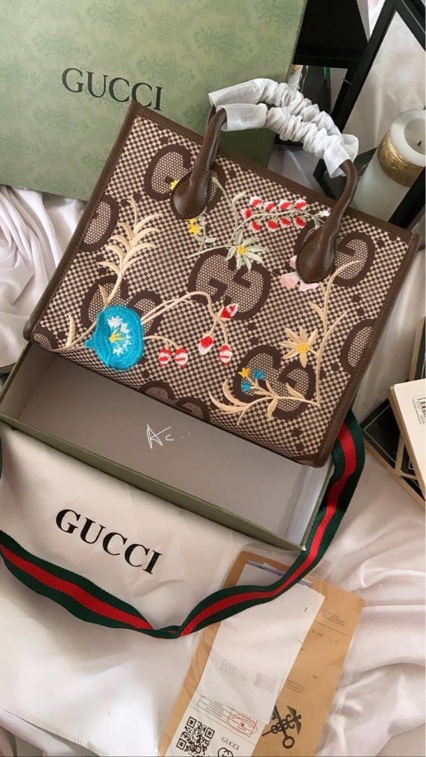 Gucci Embroidered Tote Bag (Category: Luxury Bags & Wallets) located in Pasay City. Submitted by khxore (Listing ID 1401382574, Image 1). Description: - Gucci tote bag - Embroidered floral design - Brown leather handle - Detachable shoulder strap with green and red stripe - Interior zipper pocket and fabric lining - Made in Italy - Not sure about the authenticity of the bag so selling it for a low price! .