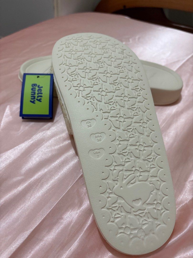 Jelly Bunny Slides (Category: Slippers and slides) located in San Pablo. Submitted by declutterwithmelqc (Listing ID 1401441391, Image 3). Description: - Cream-colored Jelly Bunny slides - Size USA 7 (23.9cm) - Features Jelly Bunny logo - Tag still attached - Textured strap design - Patterned sole .