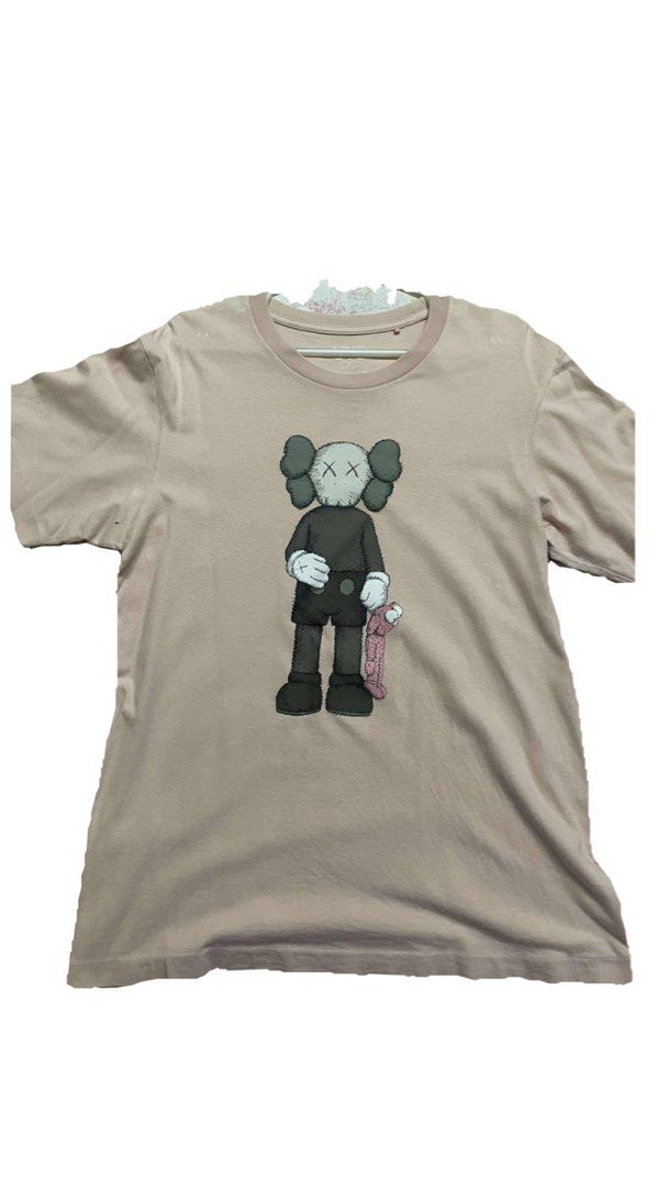 KAWS Graphic T-shirt (Category: Tshirts & Polo Shirts ) located in Manila. Submitted by declutterrrrrrrph (Listing ID 1401398875, Image 1). Description: - KAWS graphic design on the front - Crew neck - Short sleeves - Solid color - Plain back - Made of soft material.