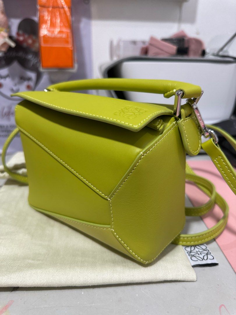 Loewe Puzzle Mini Bag - Lime Green (Category: Luxury Bags & Wallets) located in Minalin. Submitted by misissitri (Listing ID 1401483233, Image 3). Description: - Loewe Puzzle Mini Bag - Rank A, self authentication required - Coded, Sourced in Japan - SRP 145k in Ph - Vibrant lime green color - Mini size, ideal for daily use - Features a top handle and detachable shoulder strap - Unique geometric design - Secure zip closure - Fabric lined interior