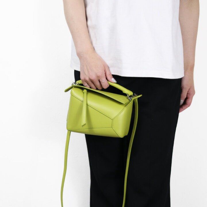 Loewe Puzzle Mini Bag - Lime Green (Category: Luxury Bags & Wallets) located in Minalin. Submitted by misissitri (Listing ID 1401483233, Image 2). Description: - Loewe Puzzle Mini Bag - Rank A, self authentication required - Coded, Sourced in Japan - SRP 145k in Ph - Vibrant lime green color - Mini size, ideal for daily use - Features a top handle and detachable shoulder strap - Unique geometric design - Secure zip closure - Fabric lined interior