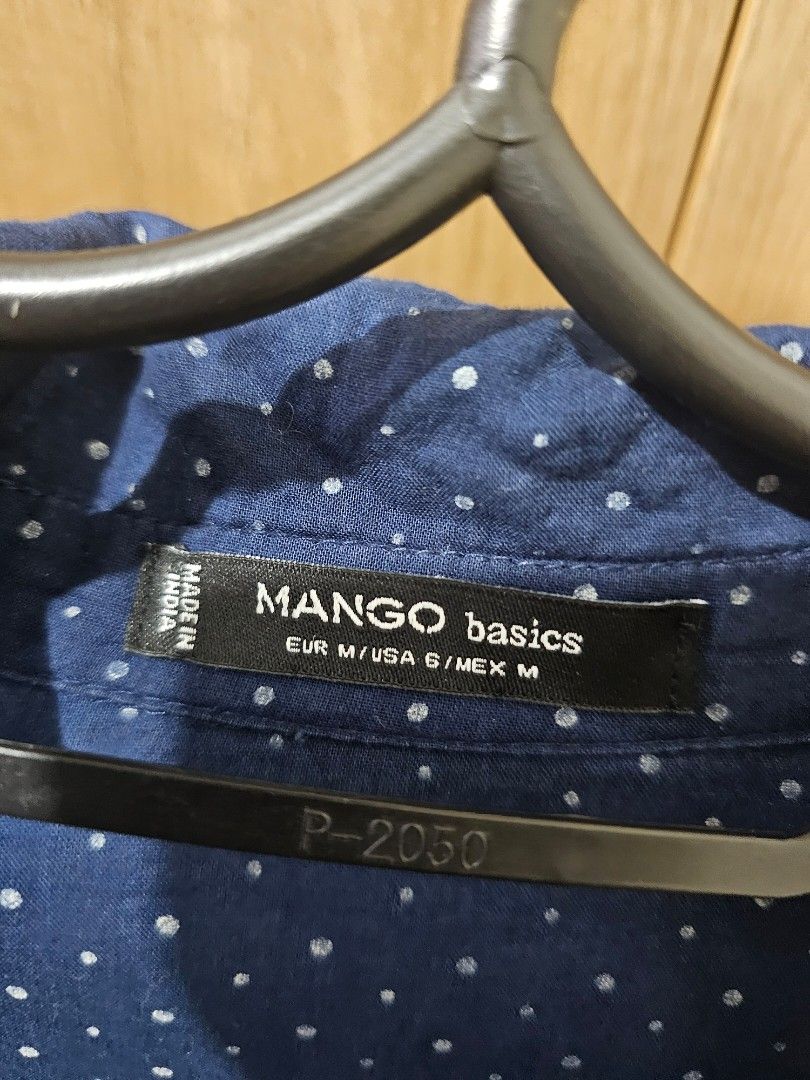 Mango Basics Dark/Navy Blue Polka Dot Shirt (Category: Shirts) located in Quezon City. Submitted by jddss (Listing ID 1401429356, Image 3). Description: Mango Basics long-sleeved shirt - Dark/Navy blue with polka dot pattern - Size on tag: M / USA 6 / MEX M - Features two chest pockets - Button-down closure - Classic collar - Made in India - Issue: 1 missing chest pocket button - RFS: Di na kasya 🥲 Please feel free to message for inquiries! 😊.