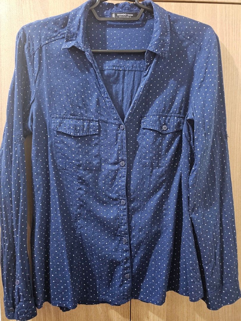 Mango Basics Dark/Navy Blue Polka Dot Shirt (Category: Shirts) located in Quezon City. Submitted by jddss (Listing ID 1401429356, Image 1). Description: Mango Basics long-sleeved shirt - Dark/Navy blue with polka dot pattern - Size on tag: M / USA 6 / MEX M - Features two chest pockets - Button-down closure - Classic collar - Made in India - Issue: 1 missing chest pocket button - RFS: Di na kasya 🥲 Please feel free to message for inquiries! 😊.