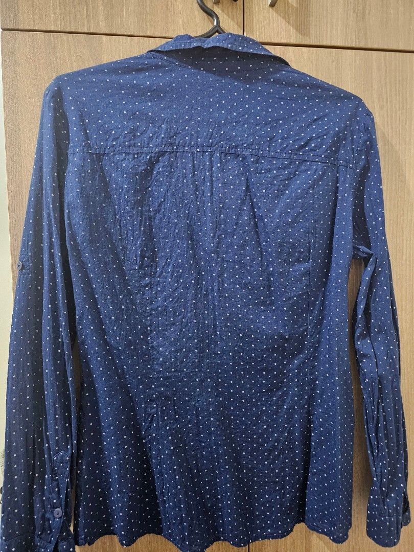 Mango Basics Dark/Navy Blue Polka Dot Shirt (Category: Shirts) located in Quezon City. Submitted by jddss (Listing ID 1401429356, Image 2). Description: Mango Basics long-sleeved shirt - Dark/Navy blue with polka dot pattern - Size on tag: M / USA 6 / MEX M - Features two chest pockets - Button-down closure - Classic collar - Made in India - Issue: 1 missing chest pocket button - RFS: Di na kasya 🥲 Please feel free to message for inquiries! 😊.