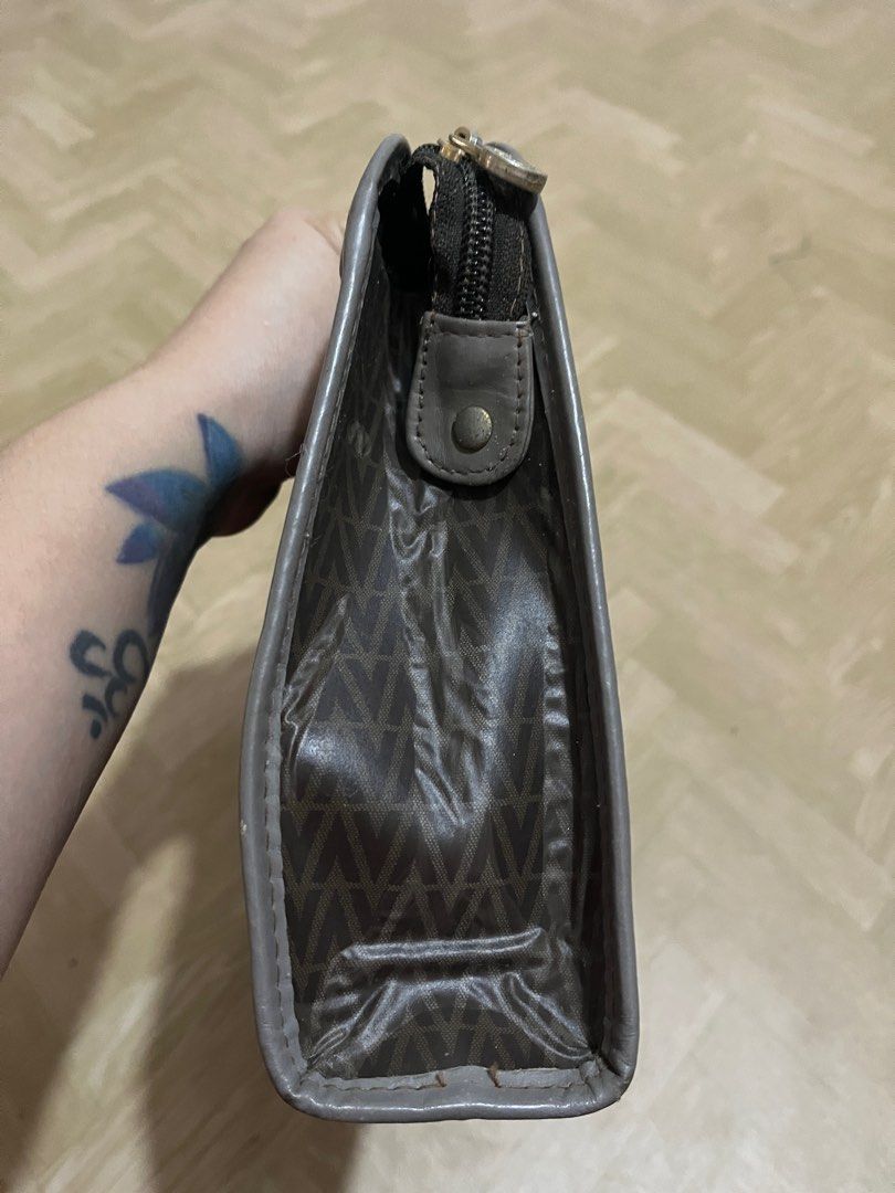 Mario Valentino Clutch Bag (Category: Luxury Bags & Wallets) located in Santiago. Submitted by luxuryfindforlessph (Listing ID 1401359807, Image 3). Description: - Mario Valentino clutch bag - Brown patterned exterior with gray trim - Gold-tone zipper closure - Gold-tone Mario Valentino logo - Made in Italy - Signs of wear on corners and edges.