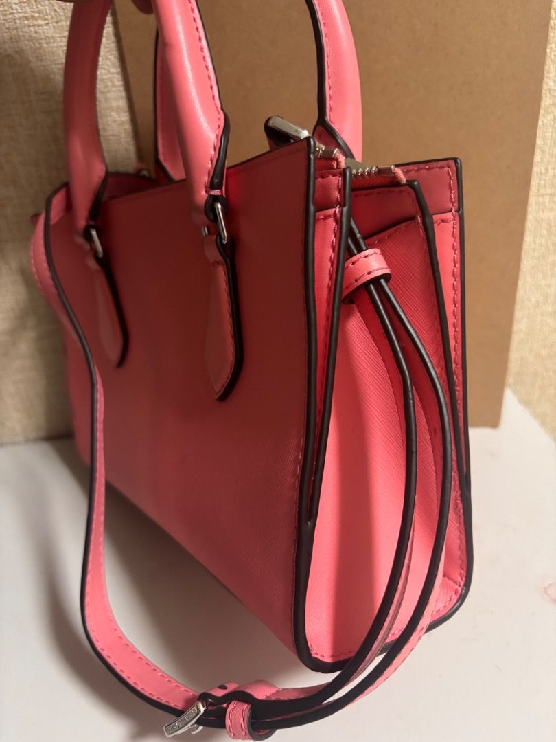 Michael Kors Sheila Satchel Handbag (Category: Luxury Bags & Wallets) located in Cebu City. Submitted by smg-origs (Listing ID 1401471784, Image 3). Description: - Authentic Michael Kors satchel handbag - Vibrant pink color - Top handle and detachable shoulder strap - Zippered main compartment - Interior pocket - Includes original packaging and tags - Michael Kors logo visible.