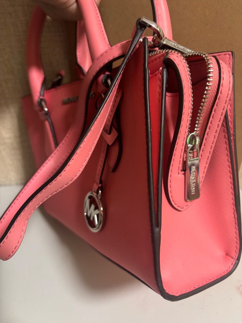 Michael Kors Sheila Satchel Handbag (Category: Luxury Bags & Wallets) located in Cebu City. Submitted by smg-origs (Listing ID 1401471784, Image 2). Description: - Authentic Michael Kors satchel handbag - Vibrant pink color - Top handle and detachable shoulder strap - Zippered main compartment - Interior pocket - Includes original packaging and tags - Michael Kors logo visible.
