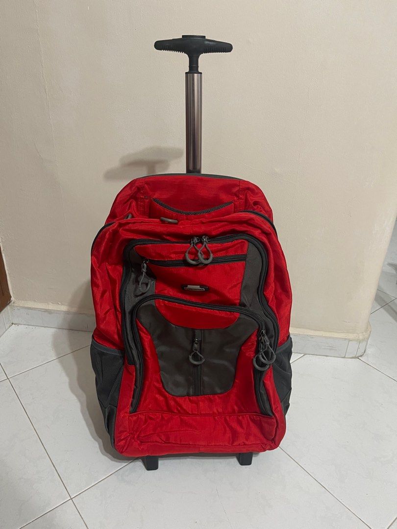 Red Rolling Backpack (Category: Backpacks) located in Singapore. Submitted by _sunsetsunrise_ (Listing ID 1401469012, Image 1). Description: - Red rolling backpack - Ideal for travel - Retractable handle and wheels for easy transport - Multiple storage compartments -Able to nego -Ctb for more -Good condition - Still fully functional.
