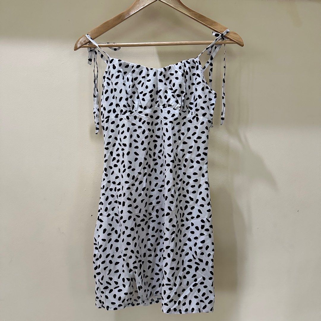 White and Black Polka Dot Dress (Category: Dresses) located in Cainta. Submitted by gentlereckless07 (Listing ID 1401399717, Image 1). Description: Used once Shein White Polkadot Mini Dress - White dress with black polka dots - tie straps, Fitted bodice - Back zipper closure - Bottom hem slit - Size XS.