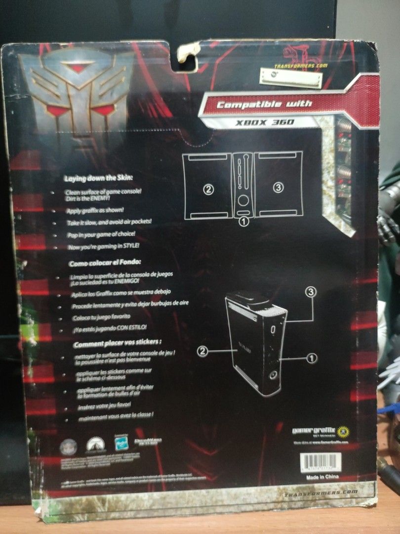 Transformers Xbox 360 Skin (Category: Xbox) located in Quezon City. Submitted by gwift (Listing ID 1401451538, Image 2). Description: - Xbox 360 Transformers Skin - Features a Decepticon emblem and character art - Removable and reusable design - Includes application instructions - Compatible with Xbox 360 console.