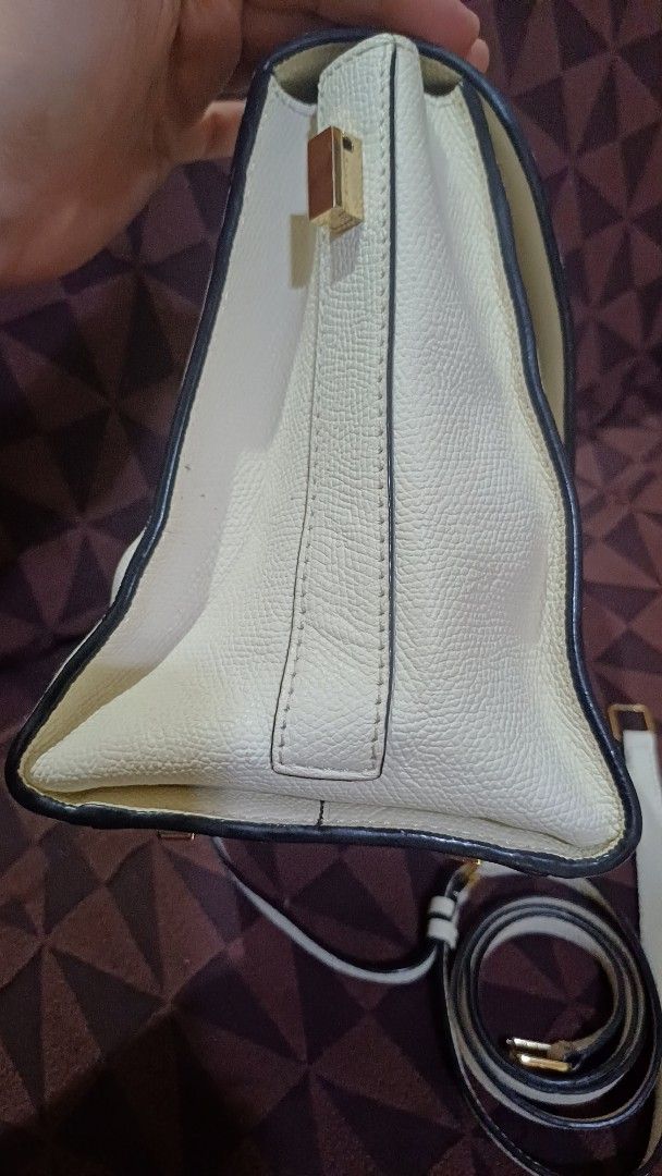 Valextra Handbag with Shoulder Strap (Category: Luxury Bags & Wallets) located in Lemery. Submitted by venus23 (Listing ID 1401483993, Image 3). Description: Elegant handbag with detachable strap. Features flap closure, gold clasp, and zippered pocket. Light color with black trim..