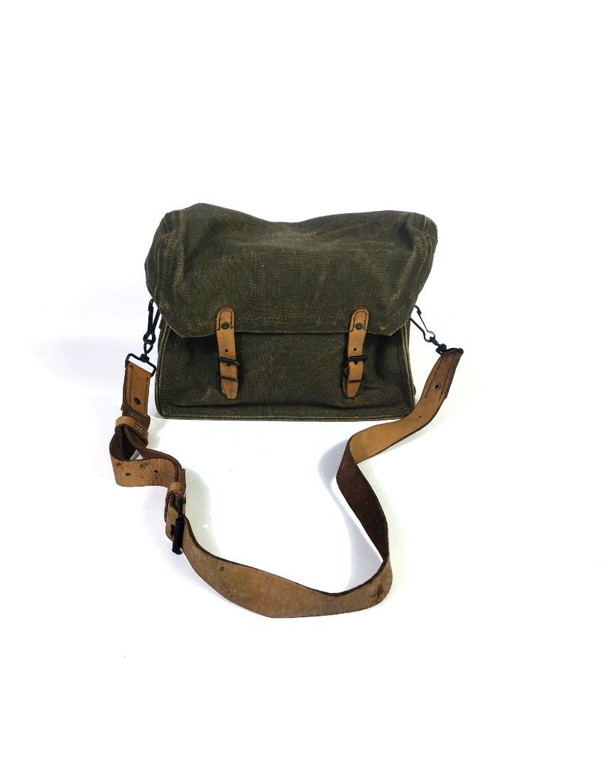 Vintage US Military Messenger Bag (Category: Luxury Bags & Wallets) located in Manila. Submitted by callmetin (Listing ID 1401523048, Image 1). Description: - Vintage messenger bag - Durable green canvas exterior - Leather accents and straps - Adjustable leather shoulder strap - Spacious interior with leather lining - Flap closure - Some markings inside - Perfect for everyday use.