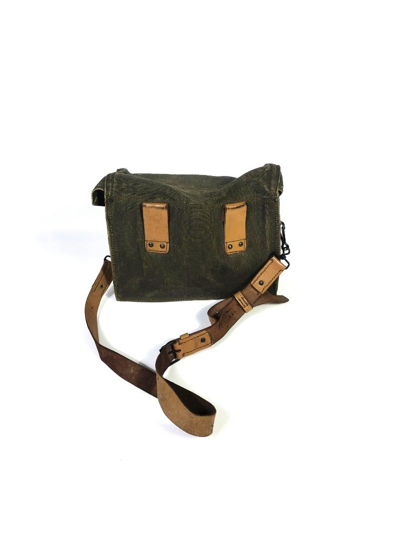 Vintage US Military Messenger Bag (Category: Luxury Bags & Wallets) located in Manila. Submitted by callmetin (Listing ID 1401523048, Image 2). Description: - Vintage messenger bag - Durable green canvas exterior - Leather accents and straps - Adjustable leather shoulder strap - Spacious interior with leather lining - Flap closure - Some markings inside - Perfect for everyday use.