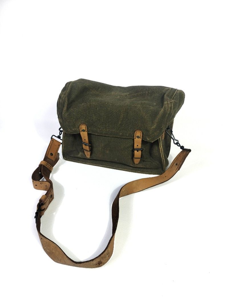Vintage US Military Messenger Bag (Category: Luxury Bags & Wallets) located in Manila. Submitted by callmetin (Listing ID 1401523048, Image 3). Description: - Vintage messenger bag - Durable green canvas exterior - Leather accents and straps - Adjustable leather shoulder strap - Spacious interior with leather lining - Flap closure - Some markings inside - Perfect for everyday use.