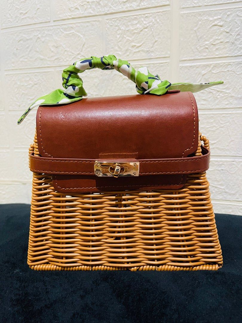 Wicker Handbag with Brown Leather Flap (Category: Luxury Bags & Wallets) located in San Pablo. Submitted by shenettdaily (Listing ID 1401355141, Image 1). Description: - Woven wicker body - Brown leather flap closure - Top handle with green and white patterned scarf - Brown leather strap - Gold-colored clasp - Spacious interior +50 sf Laguna.