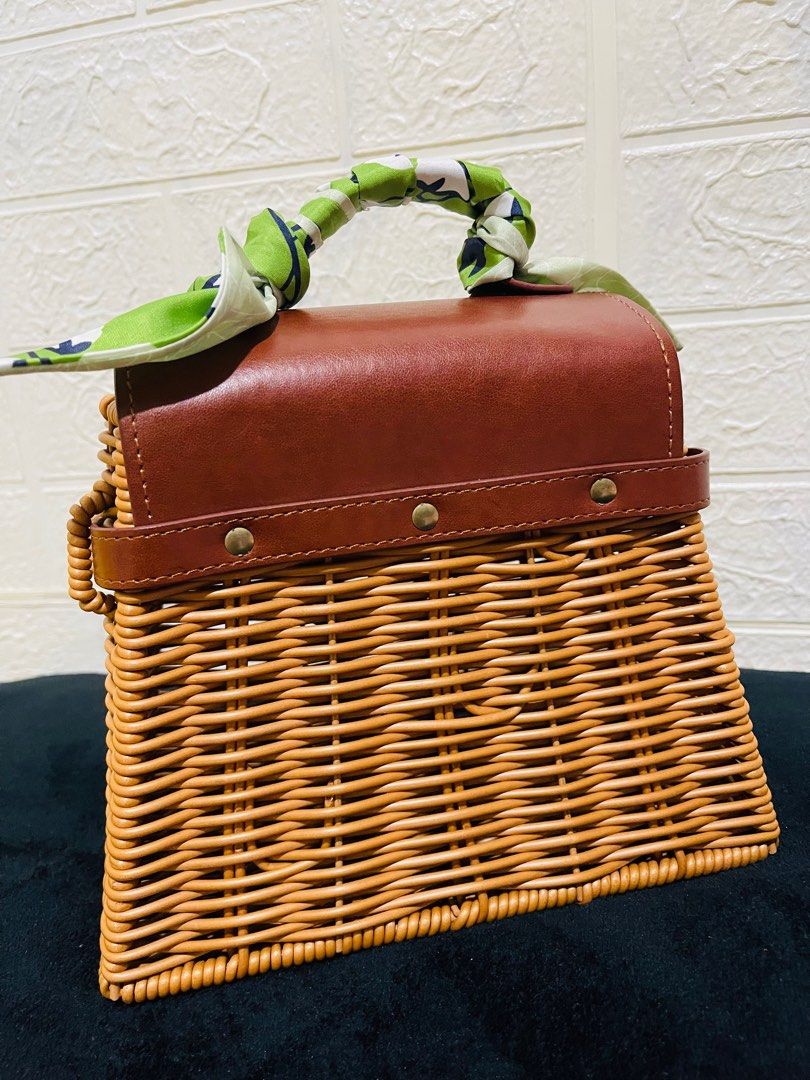 Wicker Handbag with Brown Leather Flap (Category: Luxury Bags & Wallets) located in San Pablo. Submitted by shenettdaily (Listing ID 1401355141, Image 2). Description: - Woven wicker body - Brown leather flap closure - Top handle with green and white patterned scarf - Brown leather strap - Gold-colored clasp - Spacious interior +50 sf Laguna.