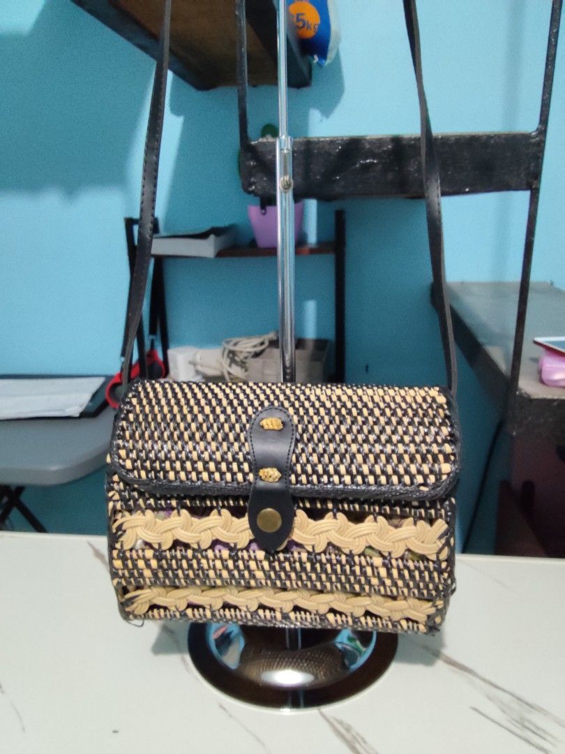 Woven Crossbody Bag with Batik Lining (Category: Cross-body Bags) located in Pasig City. Submitted by zealfish.3d4f32 (Listing ID 1401424912, Image 1). Description: - Woven crossbody bag in black and beige - Features a flap closure with a leather strap - Decorative trim - Lined with colorful batik fabric - Includes a long, adjustable strap - Ideal for everyday wear.