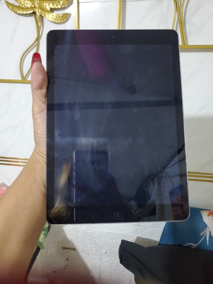 Apple iPad air 1 (Category: iPad) located in Manila. Submitted by gadialenie61782 (Listing ID 1396470903, Image 2). Description: - Apple iPad air 1 - Good working condition - Black color - Features a home button - Displays apps and settings on screen - Apple logo and "iPad" on the back - Model: MD786ZP/A.