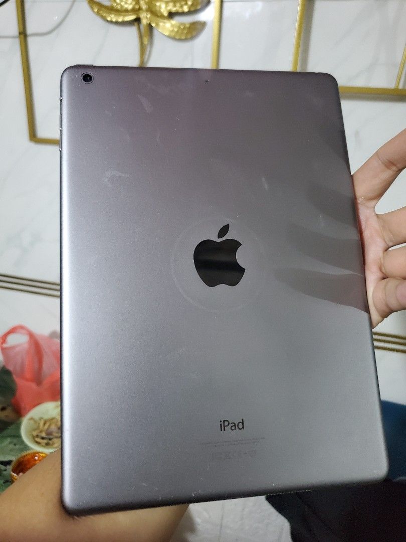 Apple iPad air 1 (Category: iPad) located in Manila. Submitted by gadialenie61782 (Listing ID 1396470903, Image 3). Description: - Apple iPad air 1 - Good working condition - Black color - Features a home button - Displays apps and settings on screen - Apple logo and "iPad" on the back - Model: MD786ZP/A.