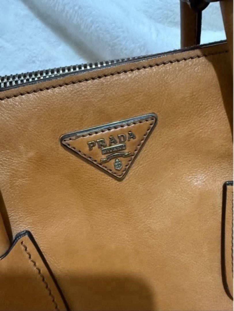 Authentic Prada Brown Glace Calf. Leather Twin Pocket (Category: Luxury Bags & Wallets) located in Paranaque City. Submitted by authentic_mj (Listing ID 1396355278, Image 2). Description: Authentic Prada Brown Glace Calf. Leather Twin Pocket Double Handle Tote Double Zip Leather Interior & Exterior Preloved Authentic from UAE No inclusions Flaws: watermarks.