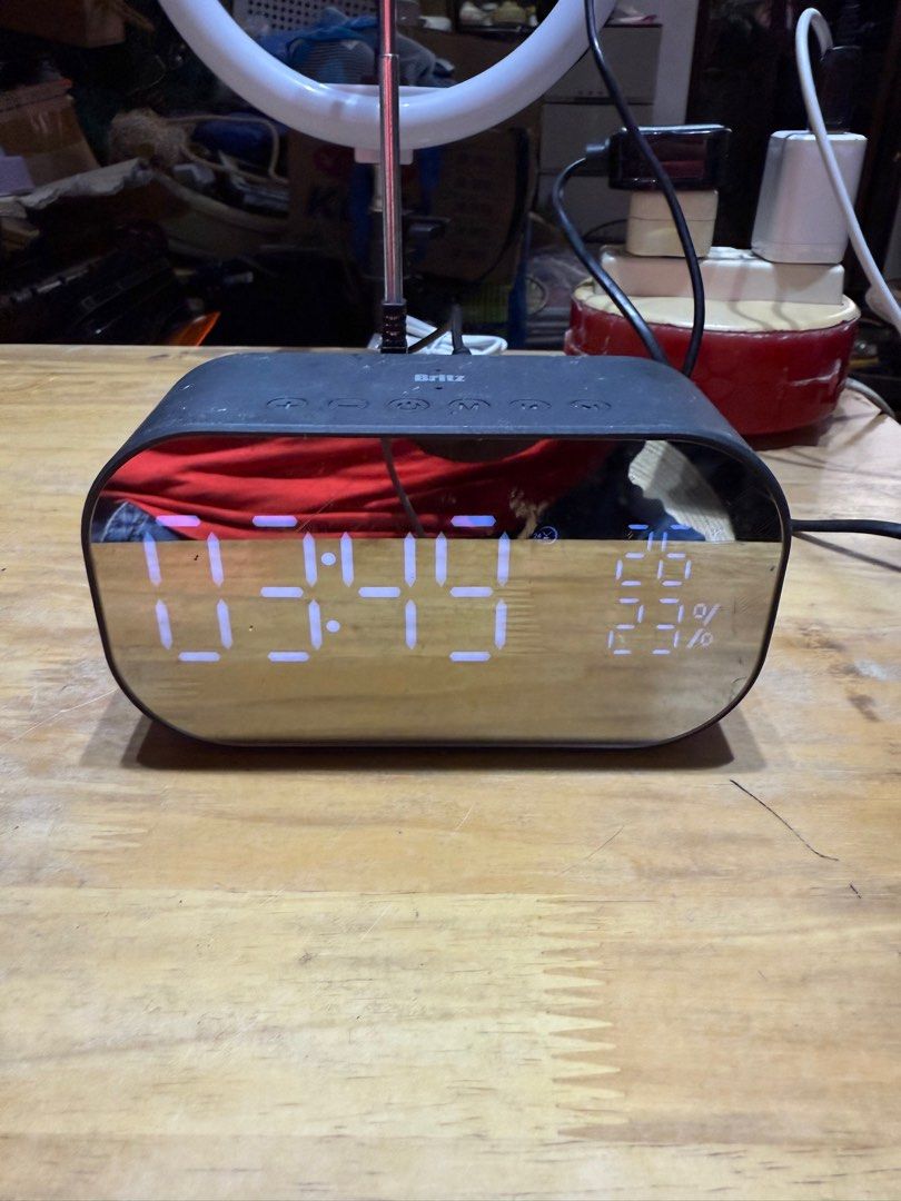Britz BZ-V900S Digital Clock Radio (Category: Portable Music Players) located in Pilar. Submitted by faveanyshop (Listing ID 1396442667, Image 1). Description: - Mirrored display: Shows time, temperature, and humidity. - Built-in FM radio. - Bluetooth connectivity. - USB and AUX ports. - Powered by DC 5V adapter. - Sleek, rectangular design. - Control buttons on top..