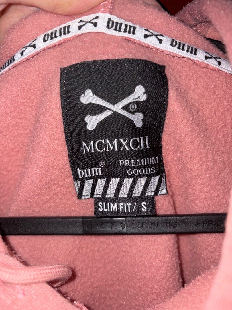 Bum Premium Goods Hoodie (Category: Hoodies) located in Quezon City. Submitted by jin_00 (Listing ID 1396378703, Image 3). Description: - Pink Bum Premium Goods hoodie - Features a skull and crossbones design - Slim fit, size S - Includes a hood and front pocket - Bum logo detail on the neckline.