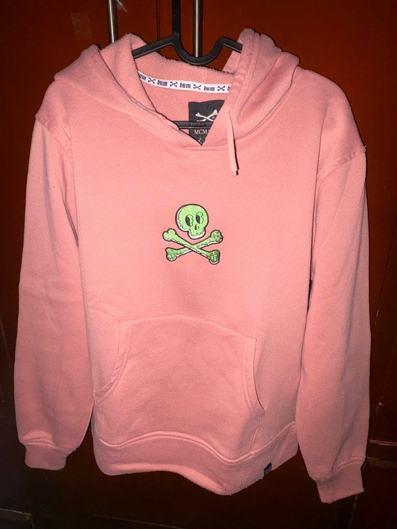 Bum Premium Goods Hoodie (Category: Hoodies) located in Quezon City. Submitted by jin_00 (Listing ID 1396378703, Image 1). Description: - Pink Bum Premium Goods hoodie - Features a skull and crossbones design - Slim fit, size S - Includes a hood and front pocket - Bum logo detail on the neckline.