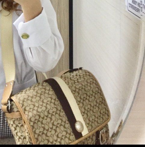 Coach Voyager Messenger Bag School Bag (Category: Luxury Bags & Wallets) located in Quezon City. Submitted by louiesaaa (Listing ID 1396455615, Image 3). Description: -Good as new - Brown and beige monogram pattern - Central stripe detail - Two front pockets with buckle closures - Coach logo emblem .