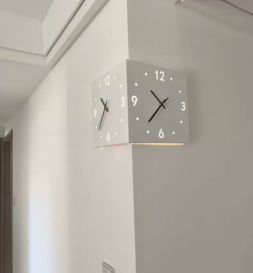 Corner Wall Clock (Category: Clocks) located in Kota Bharu. Submitted by Bonza (Listing ID 1396286451, Image 2). Description: - Unique corner wall clock - Square design - White color - Illuminated dots for hours - Two-faced design - Black hands.