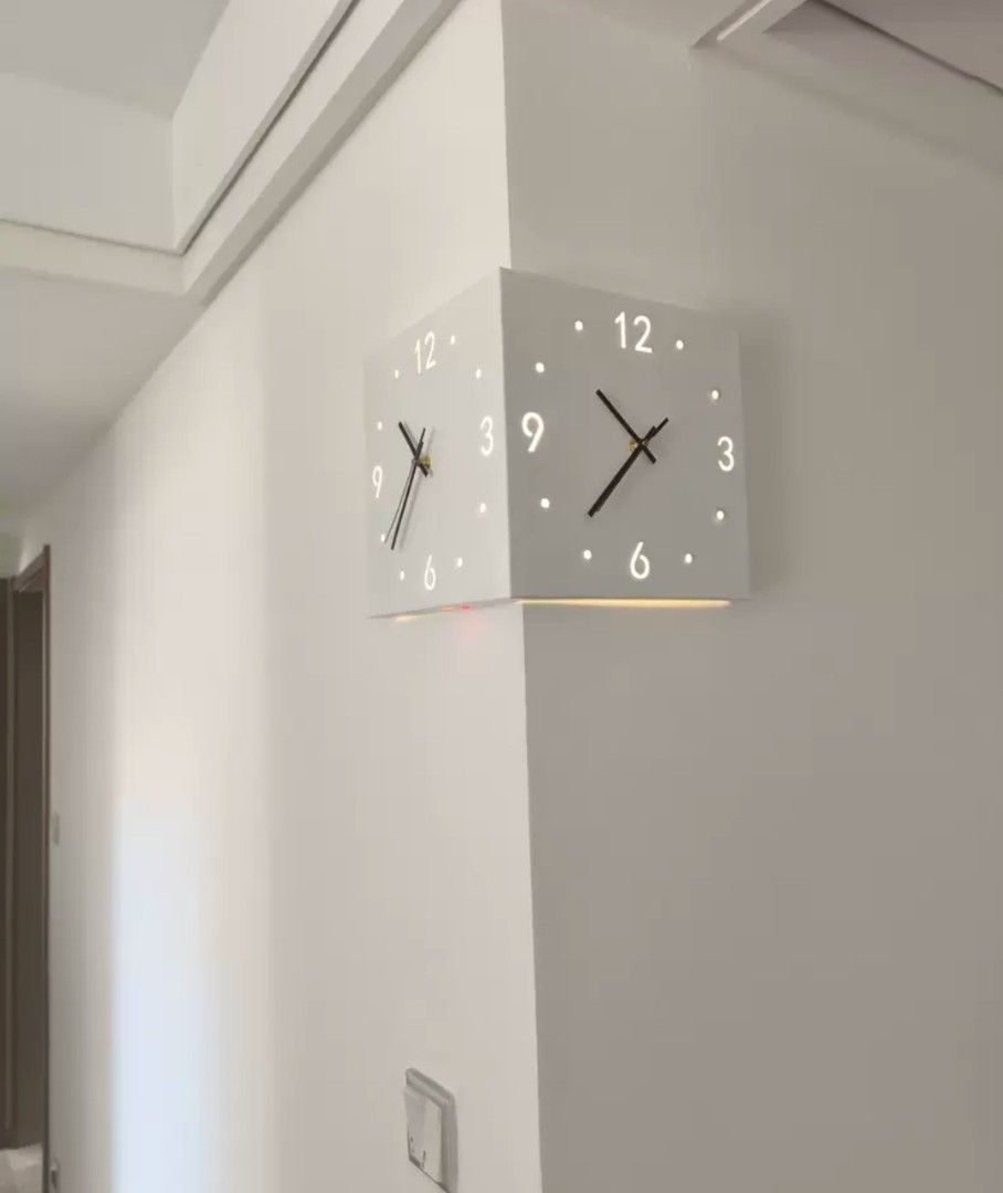 Corner Wall Clock (Category: Clocks) located in Kota Bharu. Submitted by Bonza (Listing ID 1396286451, Image 1). Description: - Unique corner wall clock - Square design - White color - Illuminated dots for hours - Two-faced design - Black hands.