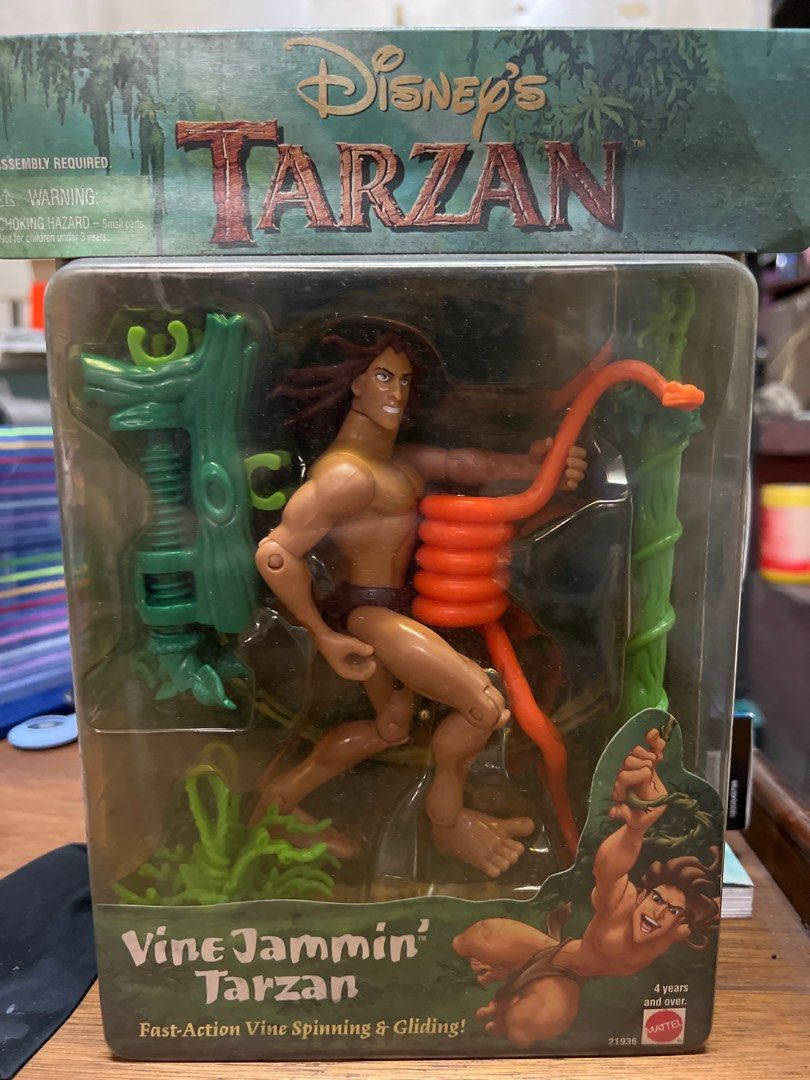 Disney's Tarzan Vine Jammin' Action Figure (Category: Figurines & Statues) located in Quezon City. Submitted by safedragon_2306ab257 (Listing ID 1396378400, Image 1). Description: - Disney's Tarzan Vine Jammin' action figure - Features Tarzan with a vine for action play - Designed for vine spinning and gliding - Brand new in original packaging - Suitable for ages 4 and up - Includes a green tree structure and an orange vine.