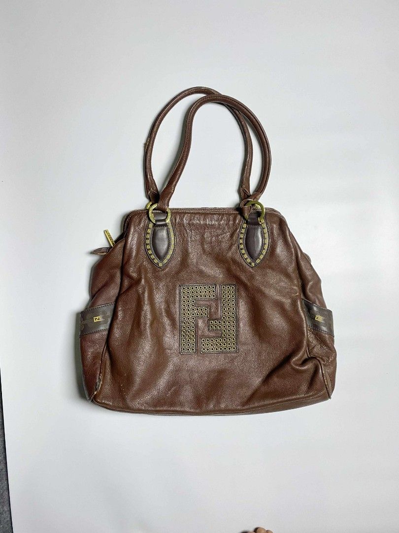 Fendi Brown Leather Handbag (Category: Luxury Bags & Wallets) located in Tarlac. Submitted by pearl_xoxo (Listing ID 1396329693, Image 1). Description: Fendi Leather Bag Off/ Legit Size: large Issue: Pic below - Fendi brown leather handbag - Features large Fendi logo - Two top handles - Zipper closure - Brown fabric lining with zipper pocket.