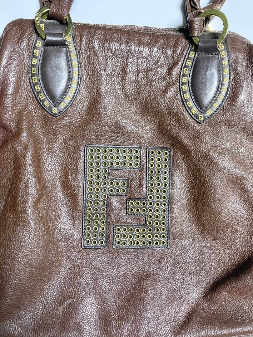 Fendi Brown Leather Handbag (Category: Luxury Bags & Wallets) located in Tarlac. Submitted by pearl_xoxo (Listing ID 1396329693, Image 3). Description: Fendi Leather Bag Off/ Legit Size: large Issue: Pic below - Fendi brown leather handbag - Features large Fendi logo - Two top handles - Zipper closure - Brown fabric lining with zipper pocket.