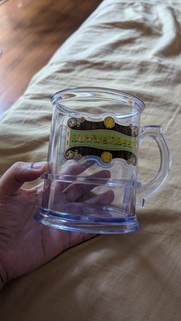 Harry Potter Butterbeer Mug Universal Studios Japan (Category: Coffee & Tea Tableware) located in Rizal. Submitted by sheitla (Listing ID 1396290680, Image 3). Description: Butterbeer Mug from Harry Potter Wizarding World Japan - Clear plastic mug - Features a Butterbeer label - Cylindrical shape with handle - Perfect for Harry Potter collectors No issues RFS: Decluttering Message me for additional pictures or inquiry.