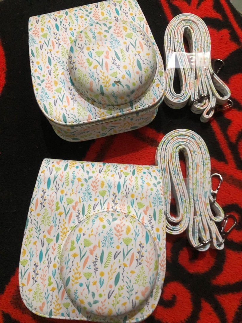 Instax mini leather padded cases (Category: Camera Bags & Carriers) located in Quezon City. Submitted by markgolveo (Listing ID 1396347959, Image 2). Description: Instax mini leather padded cases 2 pieces as set pair One piece of the pair has chip issue in front Both has slings strap intact Other piece is as good as new.