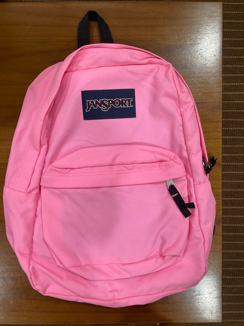Jansport Neon Pink Backpack (Category: Backpacks) located in Quezon City. Submitted by ag.decluttering (Listing ID 1396401279, Image 1). Description: - Pink Jansport backpack - Main compartment - Front zippered pocket - Top handle - Jansport logo visible - Ideal for school or daily use.