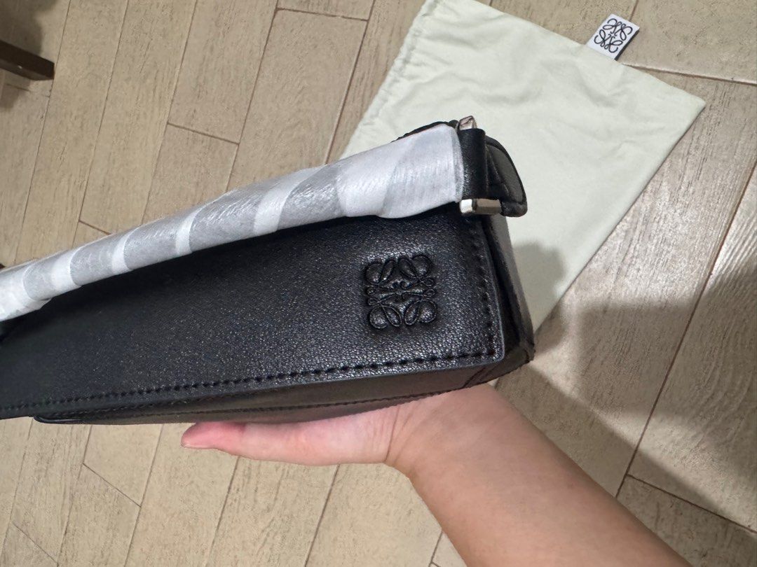 LOEWE MINI PUZZLE BAG (Category: Luxury Bags & Wallets) located in Quezon City. Submitted by glamfashionboutique (Listing ID 1396338714, Image 2). Description: Loewe Puzzle bag that everyones raving about! Comes with dustbag, strap, box Used twice but like new I have other loewe soo selling my other one Help me from decluttering.